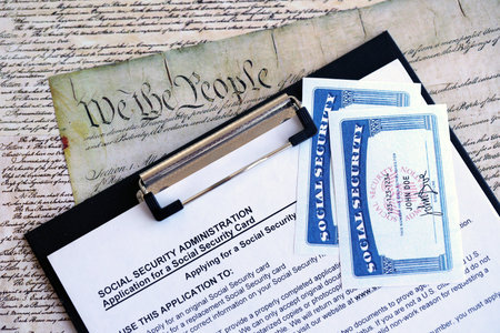 United States social security number cards lies on Application from social security administration on US Constitution page close upの写真素材