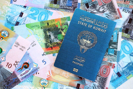 Kuwaiti dinar currency money bills and passport close up. The concept of travel and vacationの写真素材
