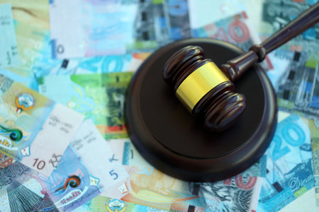 Kuwaiti dinar currency money bills and wooden judge mallet close up. The concept of judgment or...