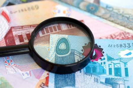 Bahraini dinar currency money bills and magnifying glass close up. The concept of financial monitoring and taxationの写真素材