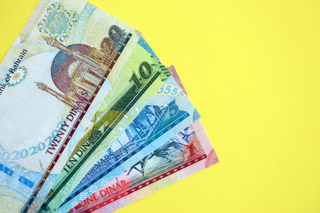 Bahraini dinar money bills in big amount on yellow close up. Finance and banking concept