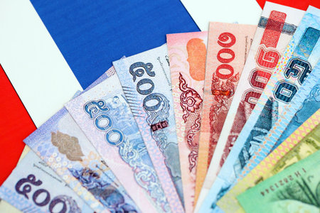 Thai baht currency money bills lies on flag close up. The concept of business and investment