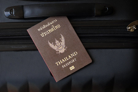 Thai passport on travel luggage close up. The concept of travel and vacation