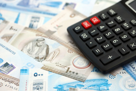 United Arab Emirates dirham currency money bills and calculator close up. The concept of taxation and money countの写真素材