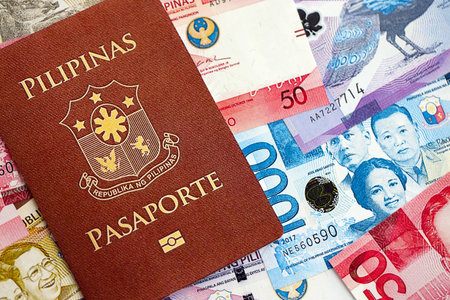Philippines peso currency money bills and passport close up. The concept of travel and vacationの写真素材