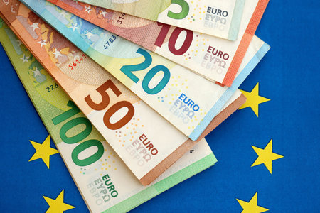 European eur currency money bills on Euro union blue flag close up. Concept of business and...