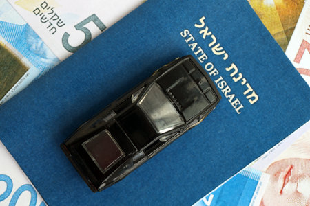 Israel New Shekels banknotes and toy car with passport. The current Israel money bills and black car...