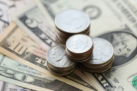 American US dollars money bills with coins and constitution close up on american flag. The American Recovery and Reinvestment Act Government Conceptの写真素材