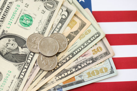 American US dollars money bills and on American flag close up. Money investment concept and...