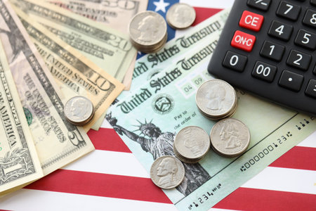 American US dollars money bills and calculator on American flag close up. Money investment concept...