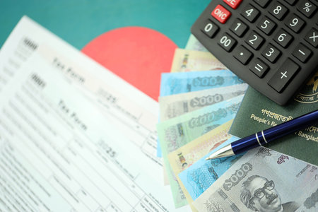 Bangladeshi taka money bills in big amount lies on table with pen, calculator, passport and tax forms close up. Finance and banking conceptの写真素材