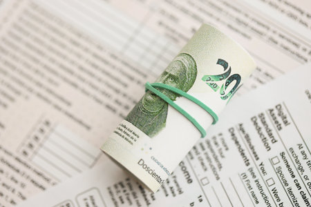 Mexican pesos money bills in big amount lies on table with tax forms close up. Accounting and taxation conceptの写真素材