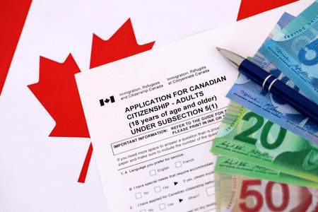 Canadian application for citizenship with money on Canadian flag close upの写真素材