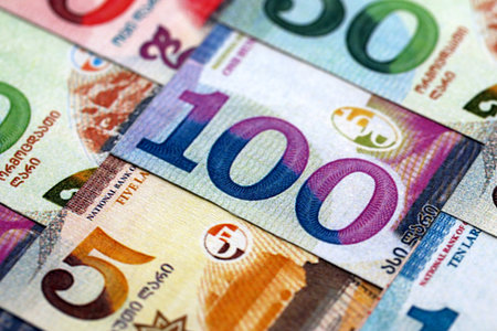 Georgian Lari currency money bills. GEL currency banknotes in pile with different denomination close...