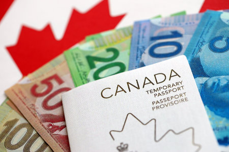Canadian temporary passport and money bills lies on flag close upの写真素材
