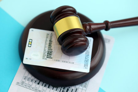 Generic driving license and judgement gavel on blue background close upの写真素材
