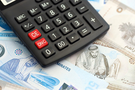 United Arab Emirates dirham currency money bills and calculator close up. The concept of taxation...