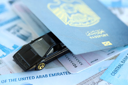 United Arab Emirates dirham currency money bills and car with passport close up. The concept of car ownershipの写真素材