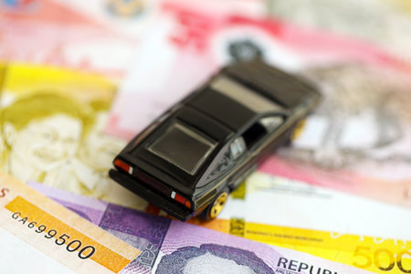 Philippines peso currency money bills and toy car close up. The concept of car ownershipの写真素材