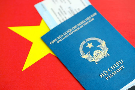 Vietnamese passport and boarding pass tickets on flag close up. The concept of travel and vacationの写真素材
