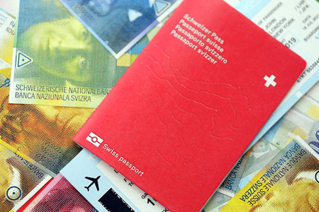 Swiss franc banknotes and passport with tickets. The current francs money bills and biometrical pass...