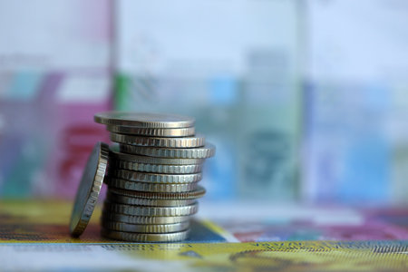 Swiss franc banknotes and coins. The current francs money bills and coins lies on table in big...