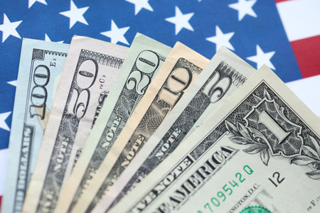 American US dollars money bills and on American flag close up. Money investment concept and taxpayingの写真素材