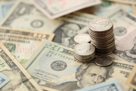 American US dollars money bills with coins and constitution close up on american flag. The American...