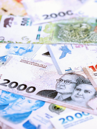 Argentine pesos money bills in big amount lies on white table close up. Finance and banking conceptの写真素材
