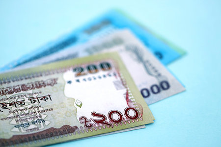 Bangladeshi taka money bills in big amount lies on teal color table close up. Finance and banking conceptの写真素材
