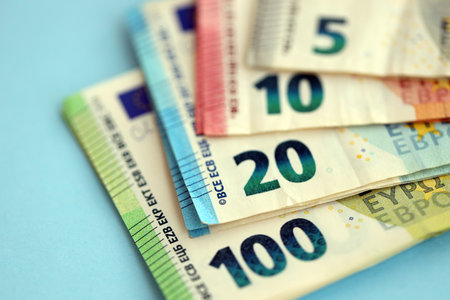 Big amount of european euro currency money notes on blue color table close up. Concept of business and income in Europeの写真素材