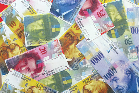 Swiss franc banknotes. The current francs money bills lies on table in big amount. The concept of business and investmentの写真素材