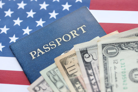 American US dollars money bills and passport with american flag close up. Travel across United States of America conceptの写真素材
