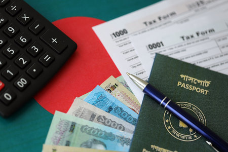 Bangladeshi taka money bills in big amount lies on table with pen, calculator, passport and tax forms close up. Finance and banking conceptの写真素材