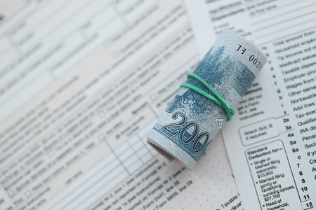 North Korean won money bills in big amount lies on table with tax forms close up. Accounting and taxation conceptの写真素材