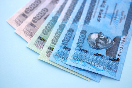 Bangladeshi taka money bills in big amount lies on teal color table close up. Finance and banking conceptの写真素材