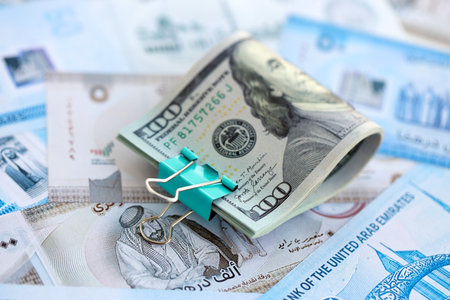 United Arab Emirates dirham currency money bills and bunch of us dollar banknotes close up. The...