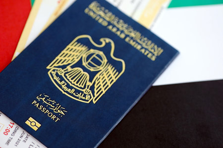 United Arab Emirates passport and boarding pass tickets on flag close up. The concept of travel and vacationの写真素材