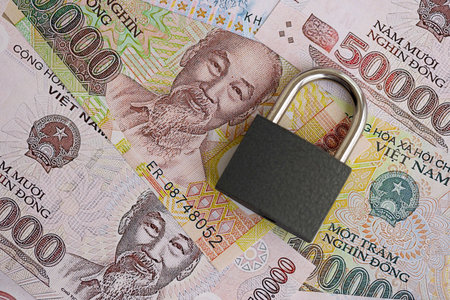 Vietnamese dong currency money bills and padlock close up. The concept of sanctions and financial safetyの写真素材