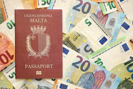 Malta passport lies on big amount of euro money banknotes close up. Rich life and travel in Europe conceptの写真素材