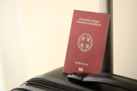 Greece passport on touristic baggage luggage in airport close up. Travel and tourism in Europe conceptの写真素材
