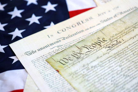 Aged historical documents Washington DC on American Declaration of independence 4th july 1776 on U.S. flag close upの写真素材