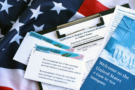 Permanent resident green card in envelope with application and guide for new immigrants lies on US...