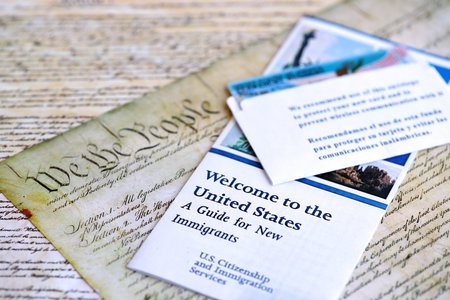 Permanent resident green card in envelope lies on US constitution page close upの写真素材