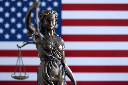 American constitution, law and legal system, statue of lady justice with scales of justice with american flag backgroundの写真素材