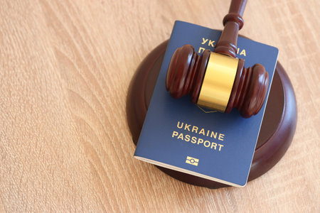 Judge gavel and ukrainian passport on brown background. Passport Of Ukraine. Obtain citizenshipの写真素材