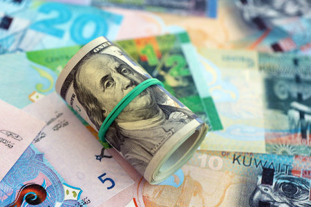 Kuwaiti dinar currency money bills and bunch of us dollar banknotes close up. The concept of economics and currency exchangeの写真素材