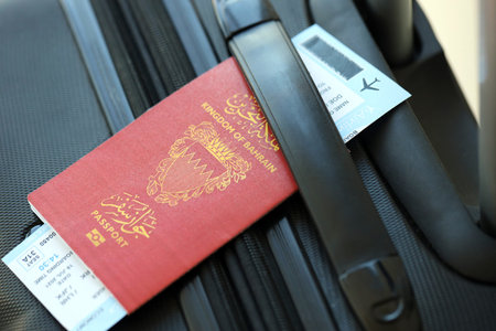 Bahraini passport and avia tickets on travel bag close up. The concept of travel and vacationの写真素材