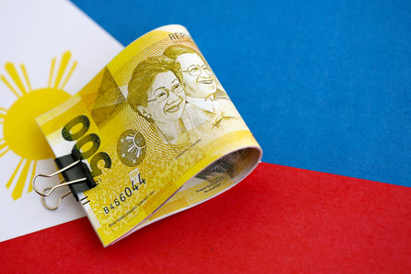 Philippines peso currency money bills lies on flag close up. The concept of business and investmentの写真素材