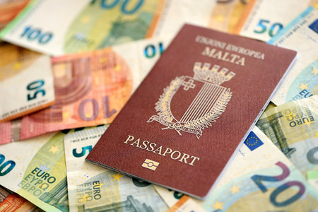 Malta passport lies on big amount of euro money banknotes close up. Rich life and travel in Europe conceptの写真素材